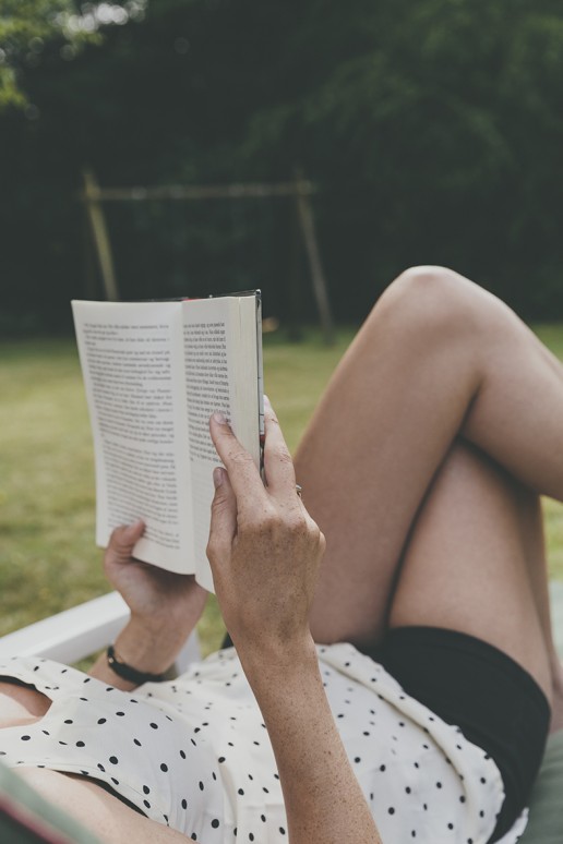 Woman reading book in garden