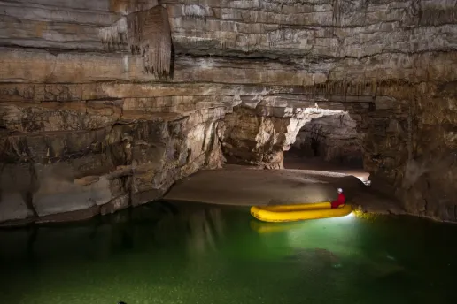 Underground boat tour on the emerald lake at Križna Cave, Slovenia